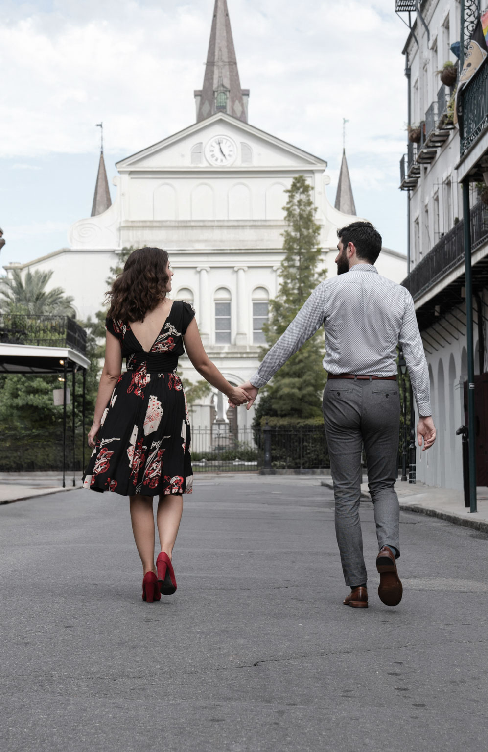 Romantic couple walking down Orleans Avenue in the New Orleans French Quarter holding hands