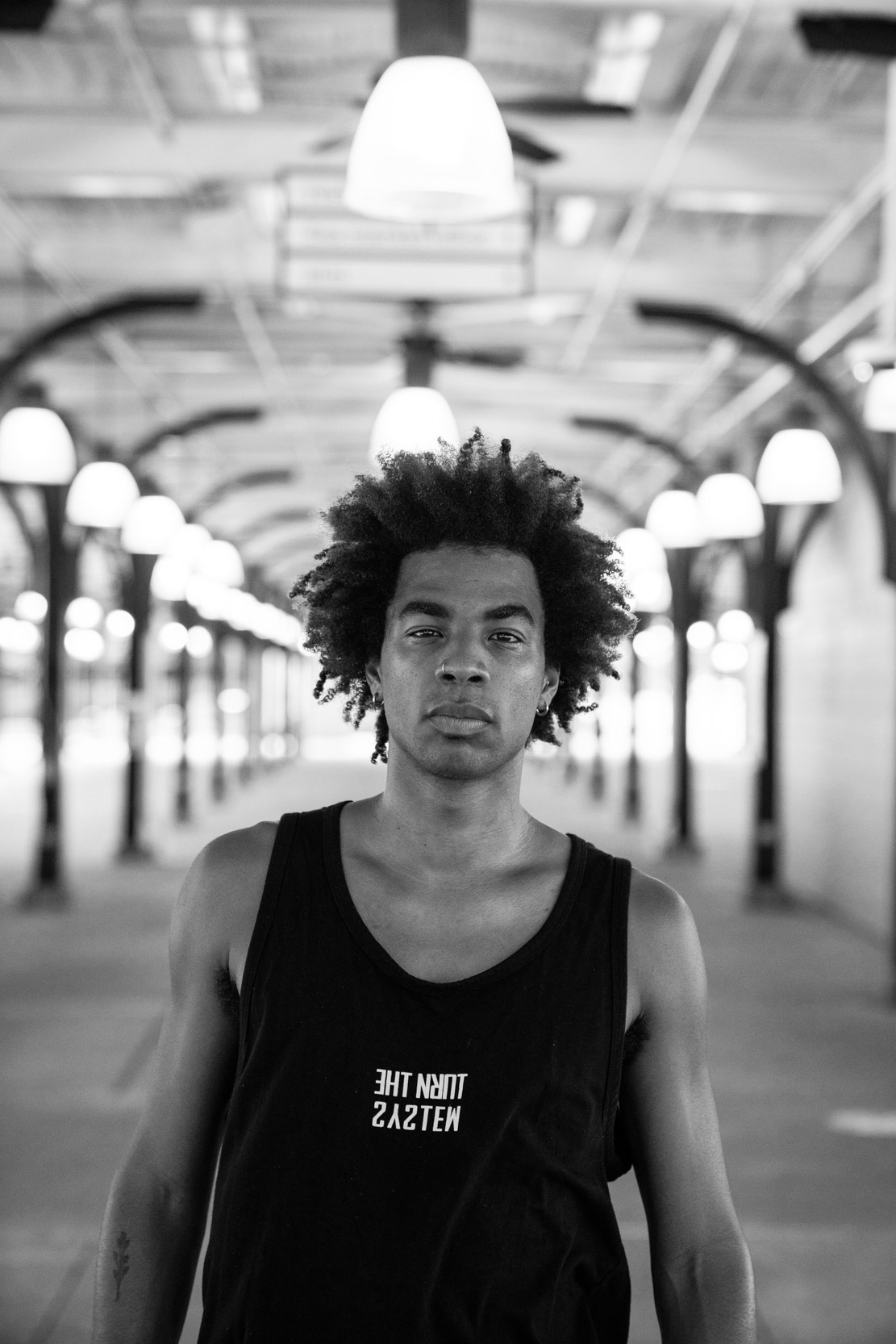 A dancer walking in a New Orleans French Quarter market with lights