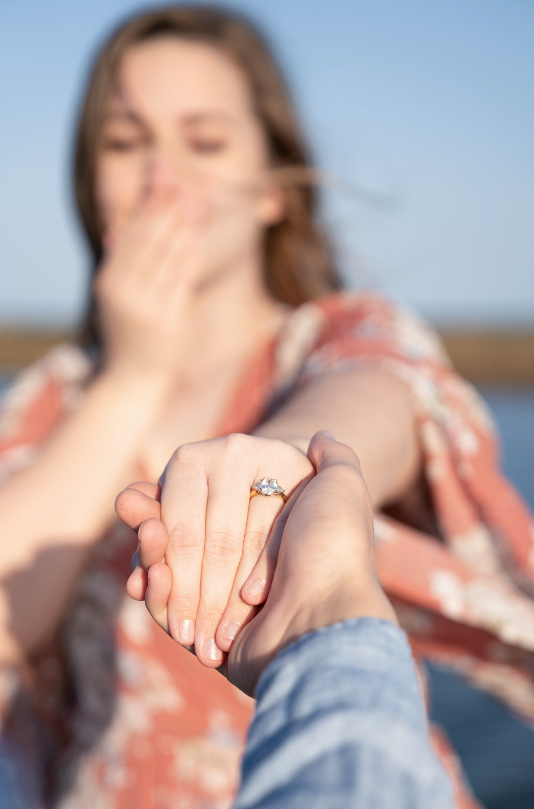 Engagement ring with couple holding hands along on a bayou vista in Louisiana