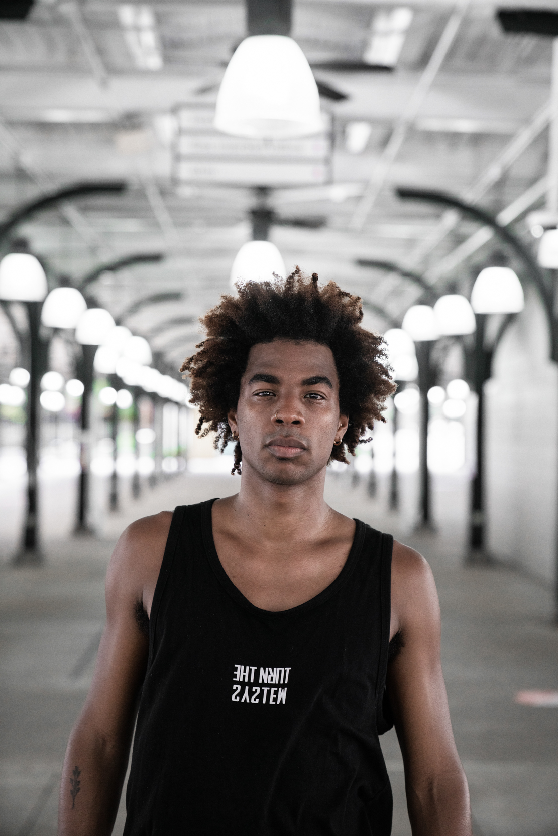 A dancer walking in a New Orleans French Quarter market with lights
