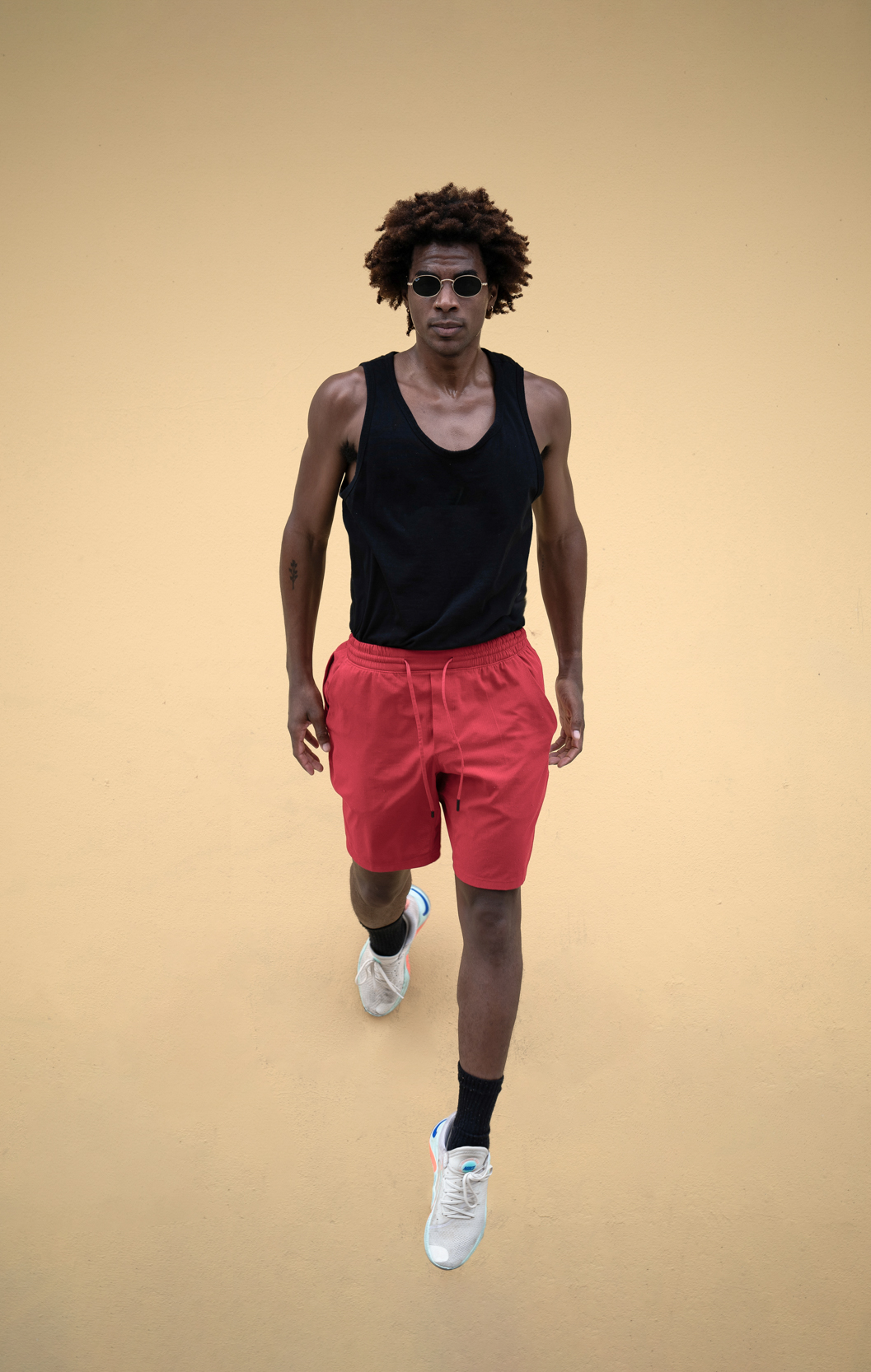 Athletic dancer dressed in fashion and jumping on a sidewalk in the New Orleans French Quarter