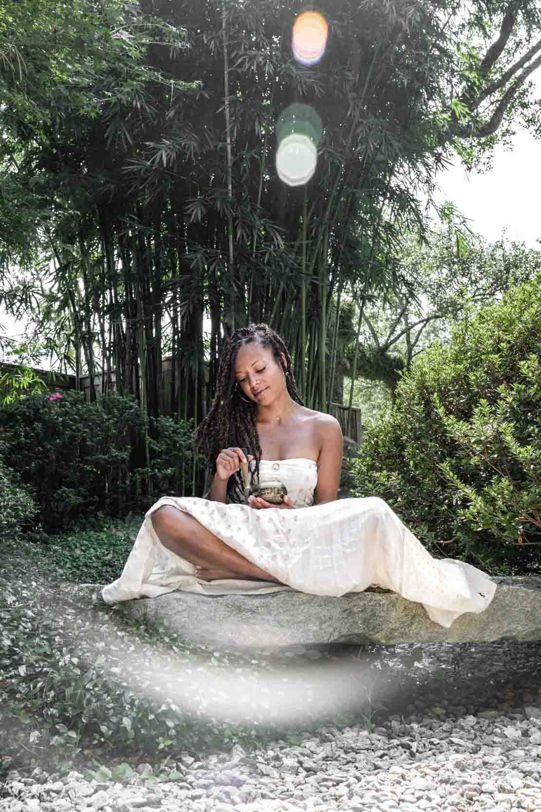 Girl meditating wearing pretty dress in New Orleans City Park Botanical Garden