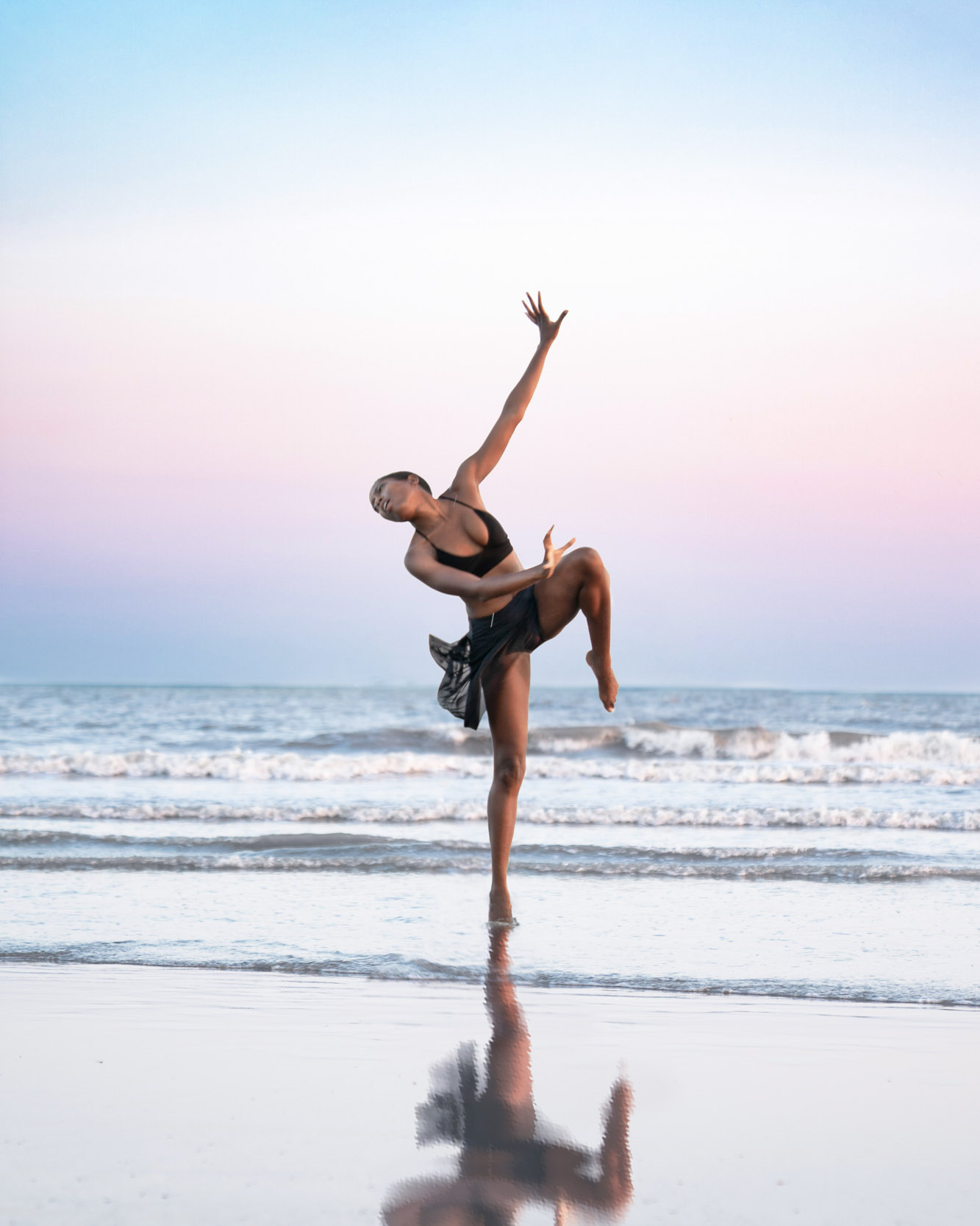 Dancer posing on the beach at sunset along Louisiana Gulf Coast