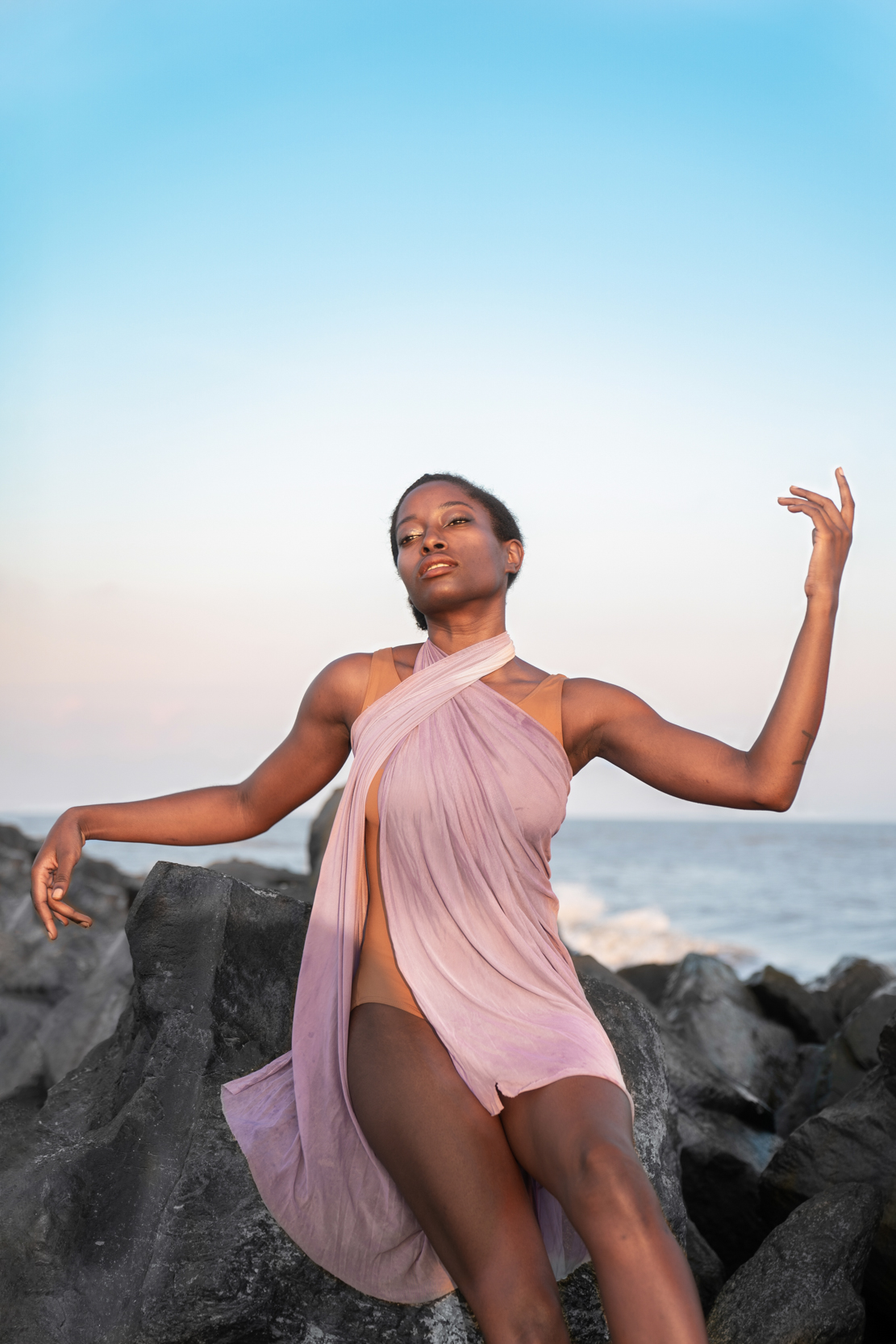 A female dancer modeling in beautiful dress on a Louisiana Gulf Coast beach at sunset