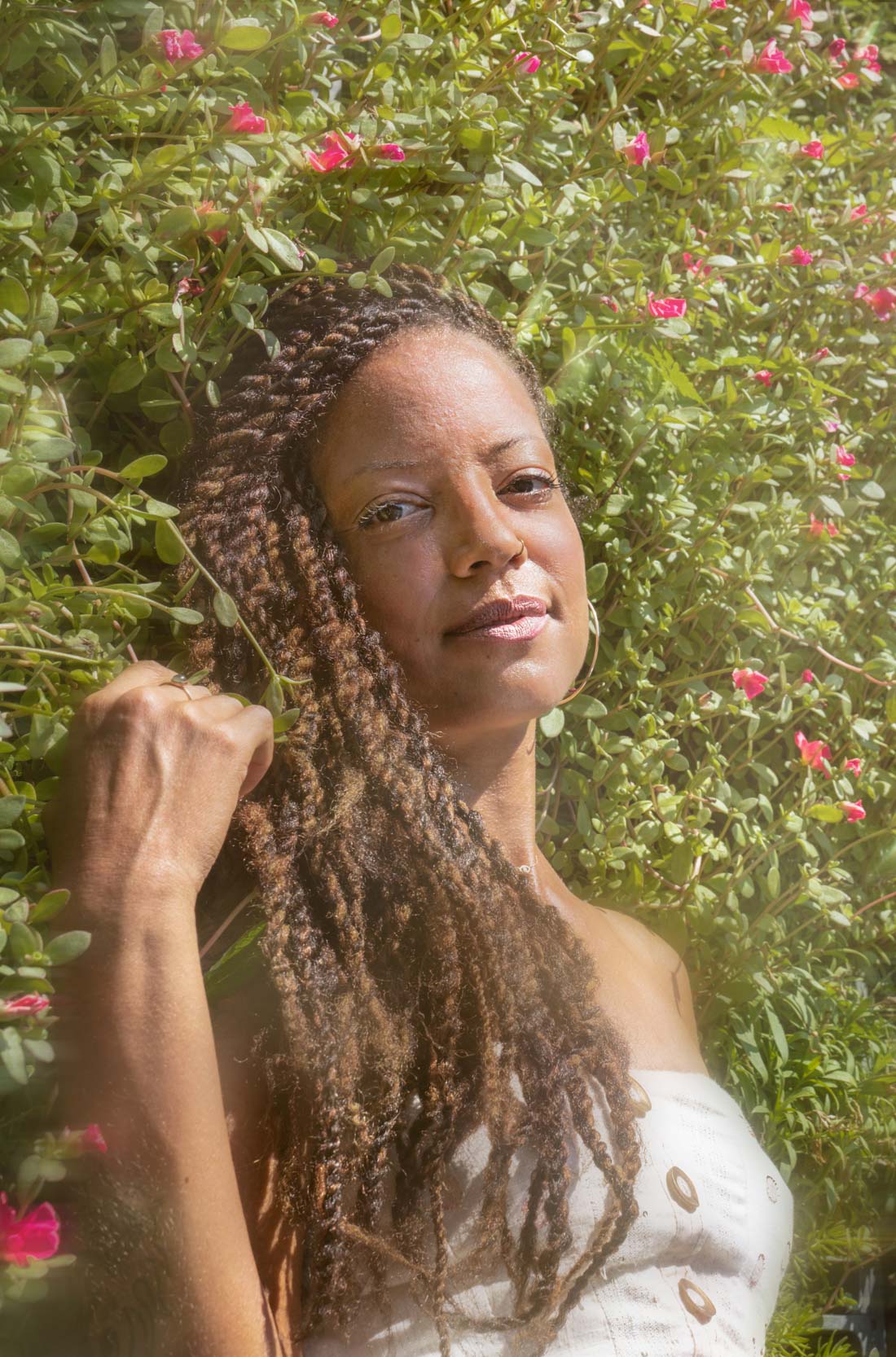 Woman modeling and smiling in a garden of flowers in New Orleans City Park