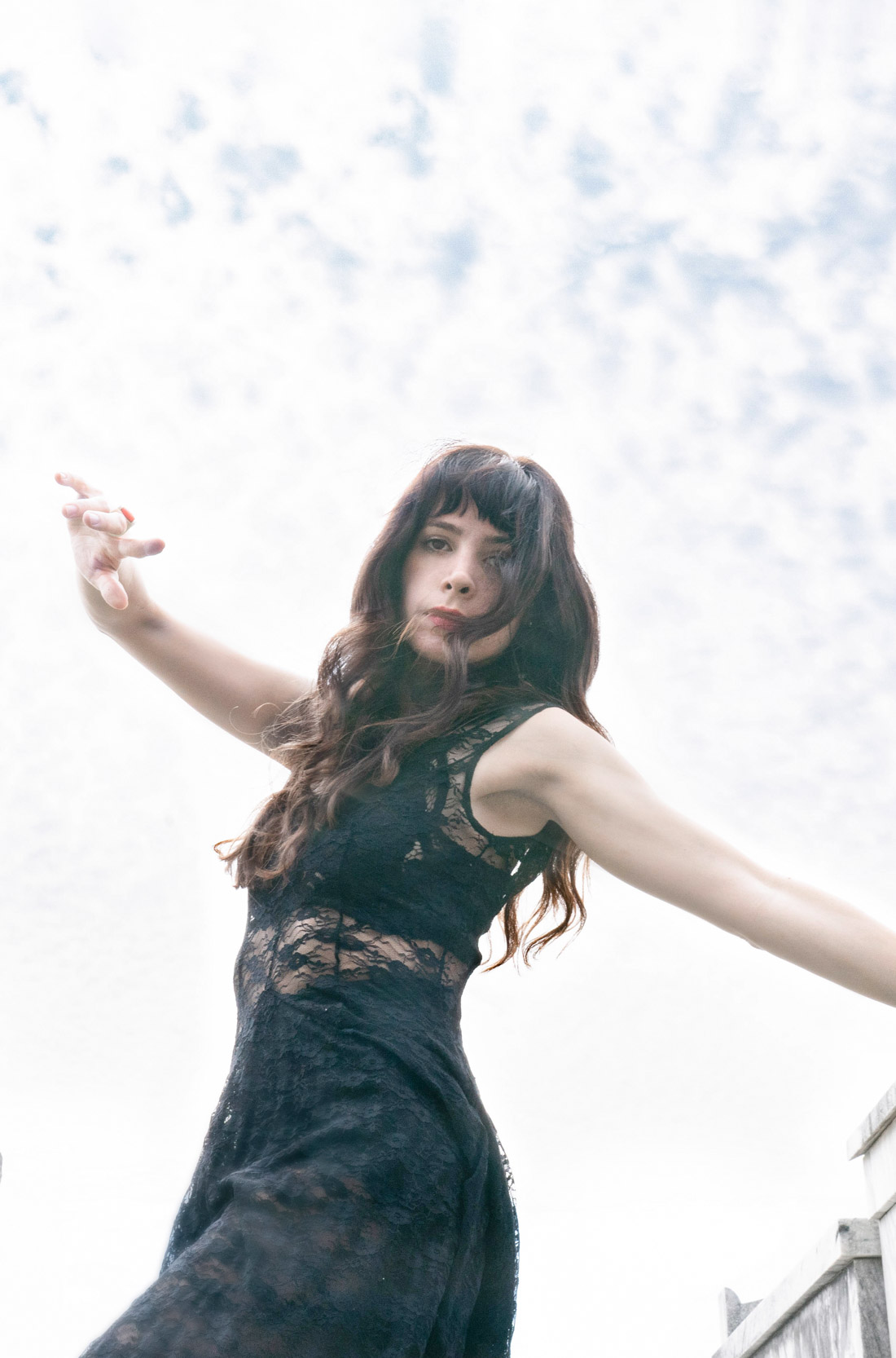 A woman dancing and posing in a New Orleans cemetery