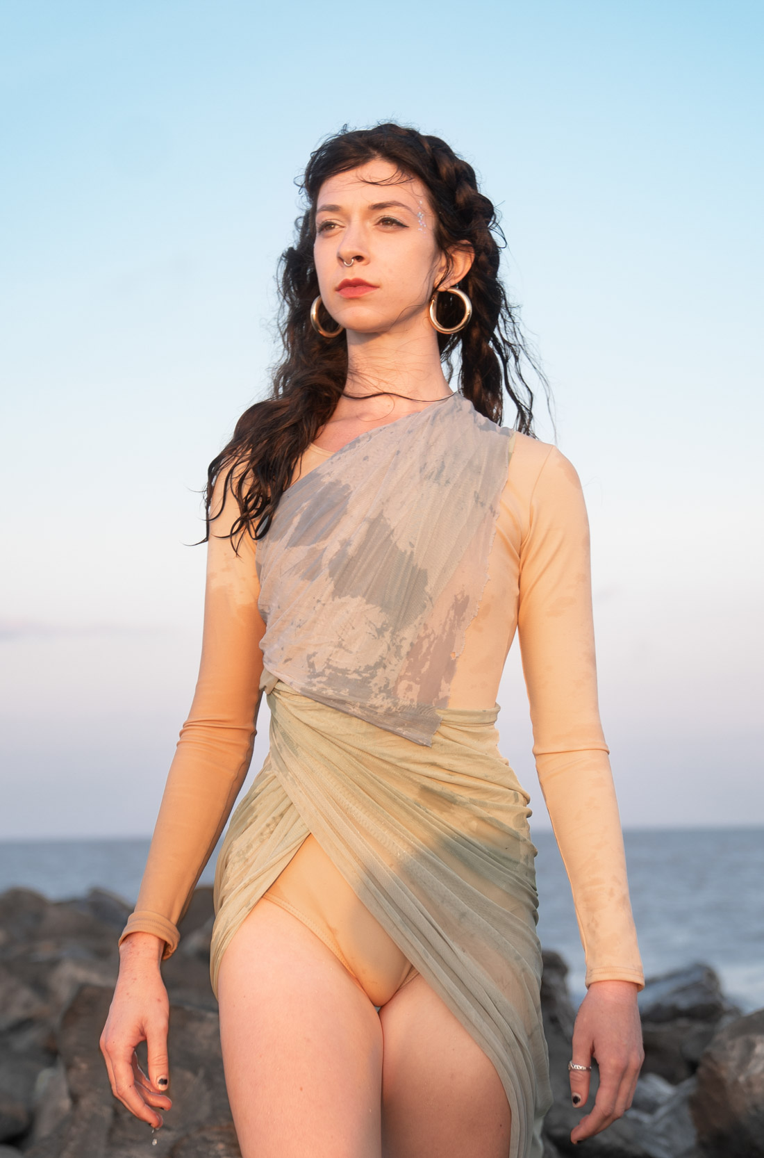 A woman modeling and dressed like a mermaid on a Louisiana Gulf Coast beach at sunset