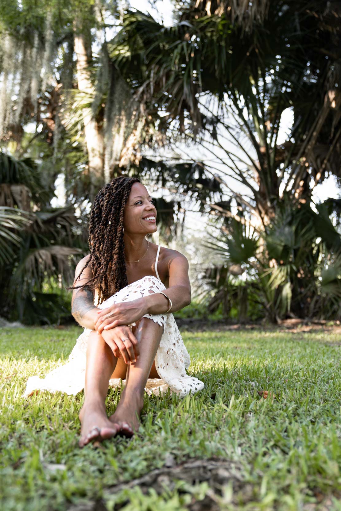 Woman smiling and lying in the grass in New Orleans City Park