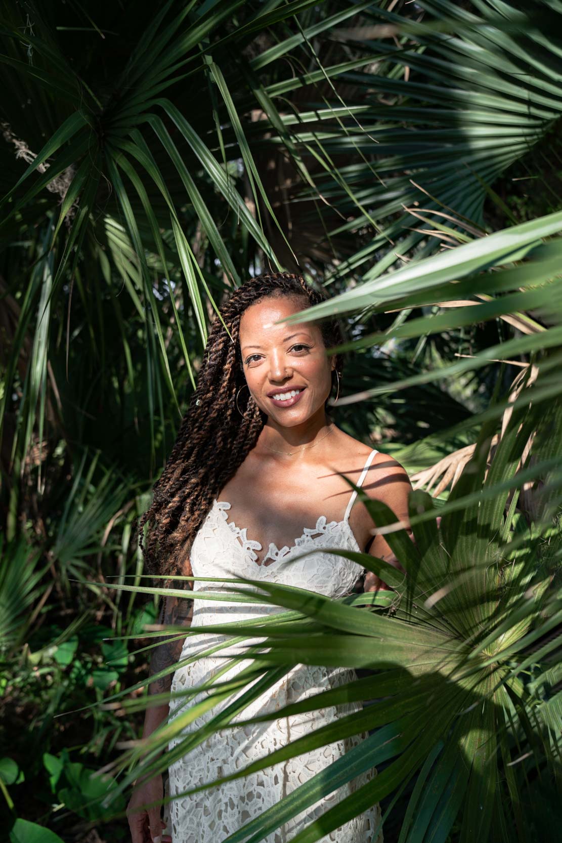 Pretty woman modeling and smiling in New Orleans City Park with palmetto trees