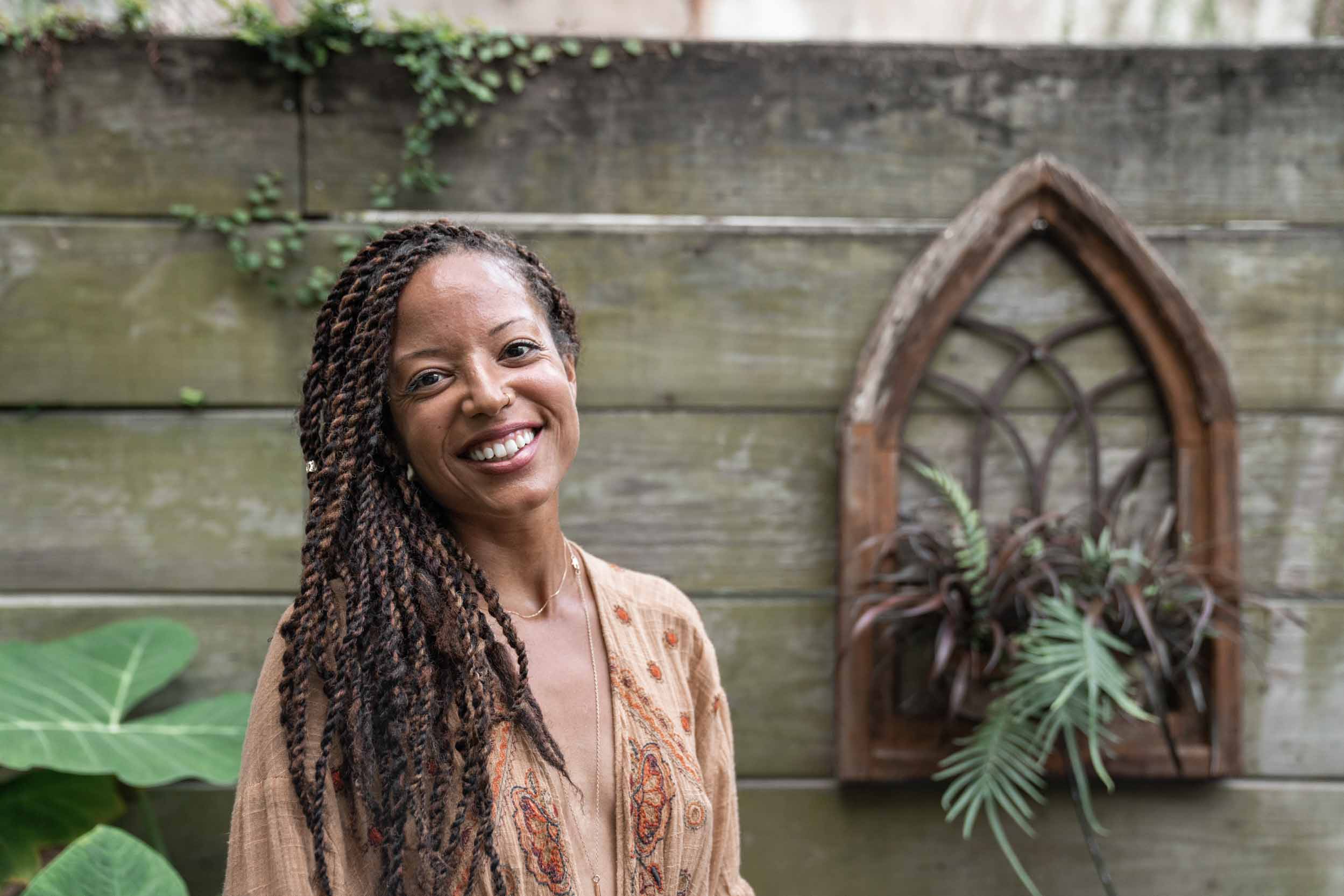 Woman enjoying herself and smiling in New Orleans French Quarter courtyard