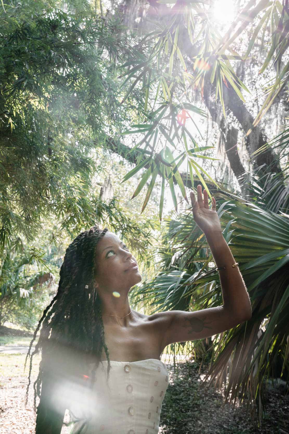 Woman walking through a small forest and touching plants in New Orleans City Park