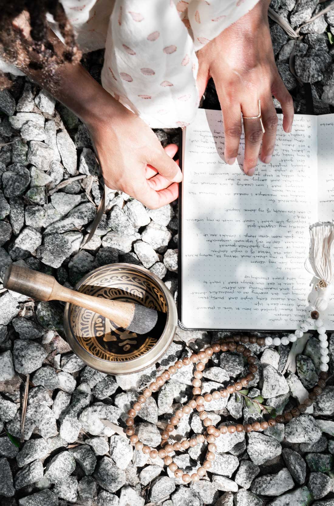 Woman reading and meditating on rocks in the New Orleans City Park Botanical Garden